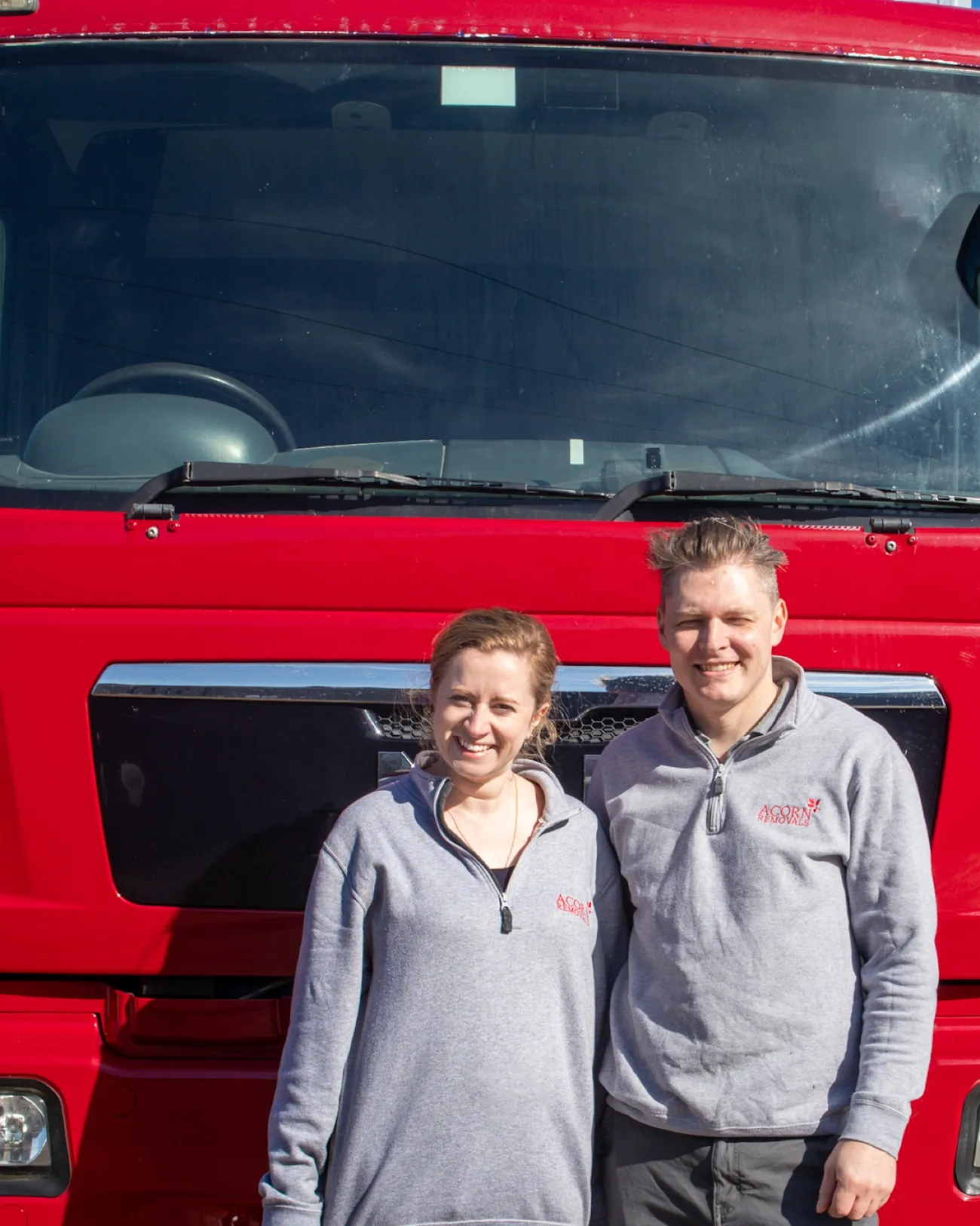 James and Tess, owners of Acorn Removals, alongside an Acorn lorry