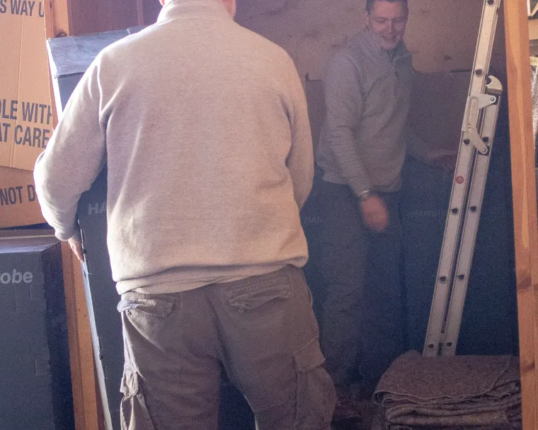 Acorn team loading a steel storage container, methodical and organised